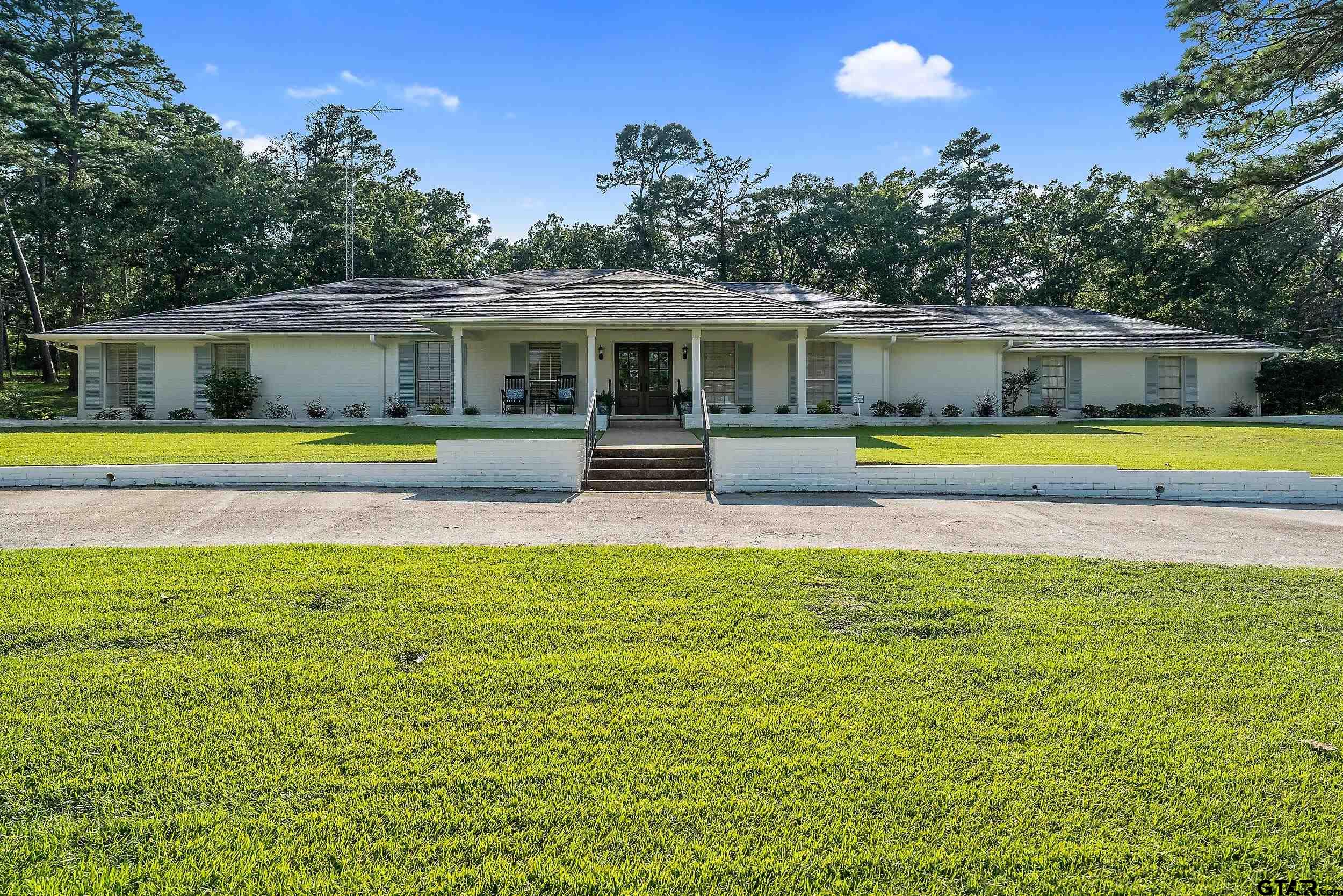a swimming pool with outdoor seating and yard