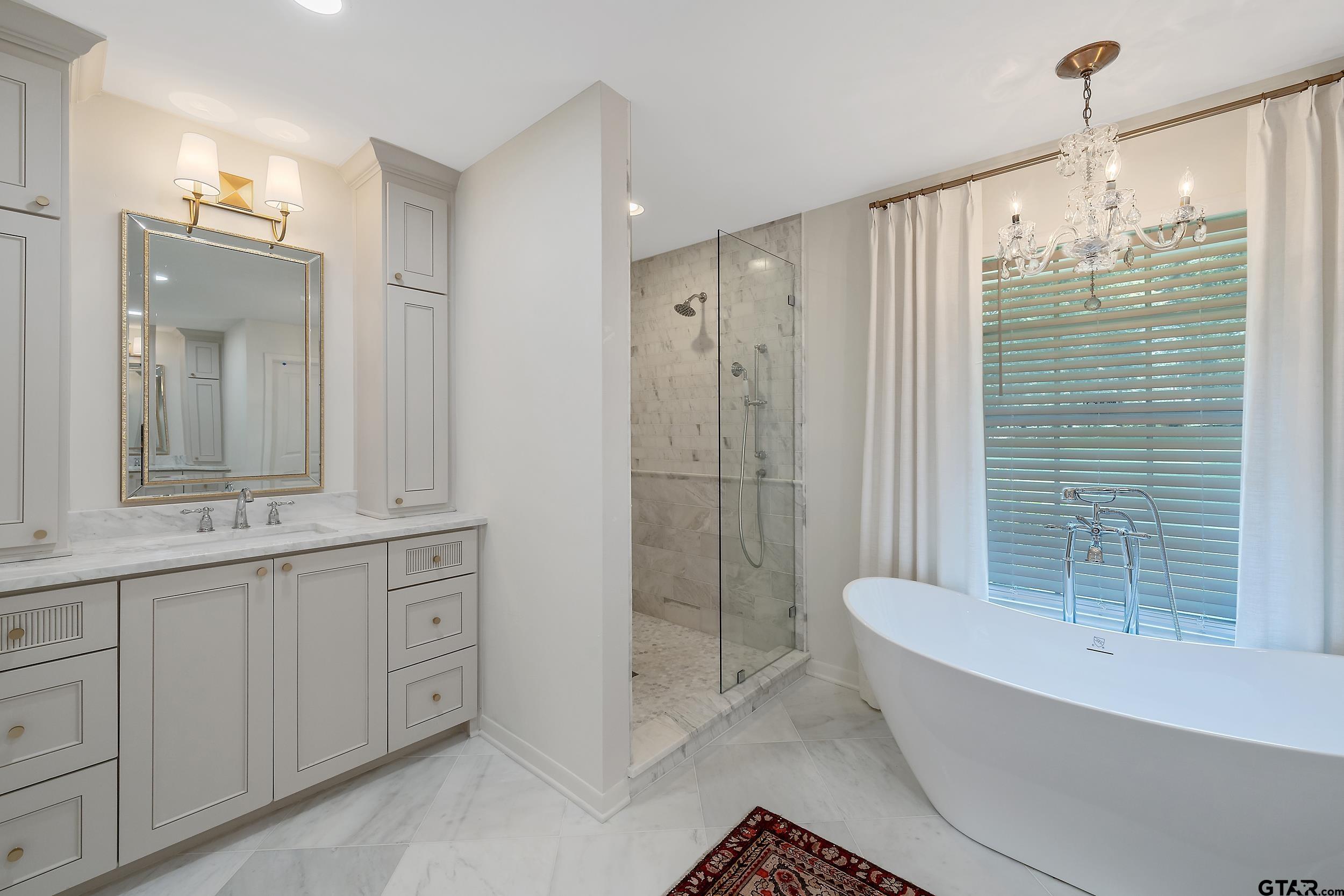 16708 Beddingfield Road Flint, TX 75762 - Photo 22 of 40 a bathroom with a bathtub a shower a sink and toilet