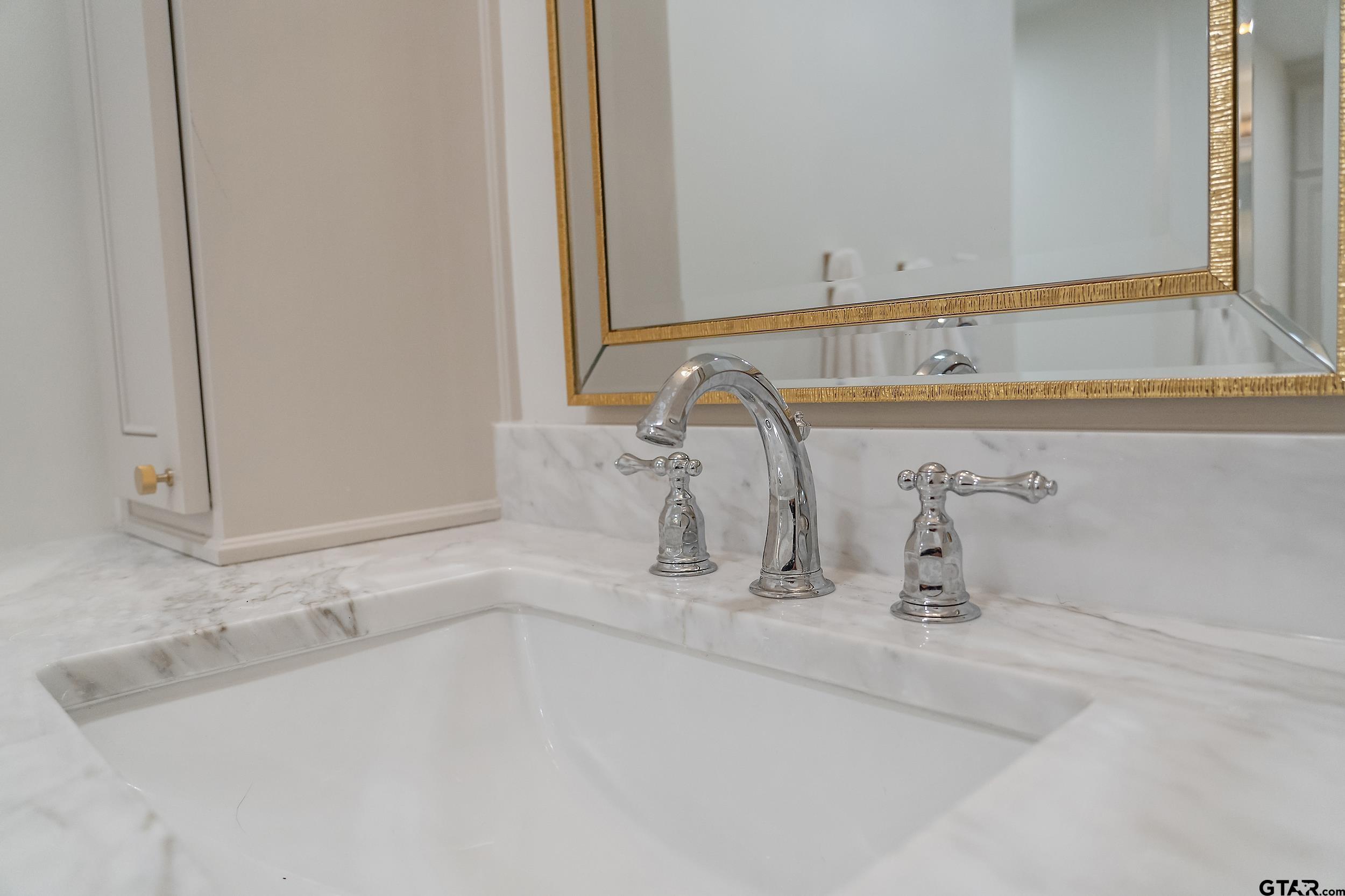 16708 Beddingfield Road Flint, TX 75762 - Photo 26 of 40 a bathroom with a sink and a mirror