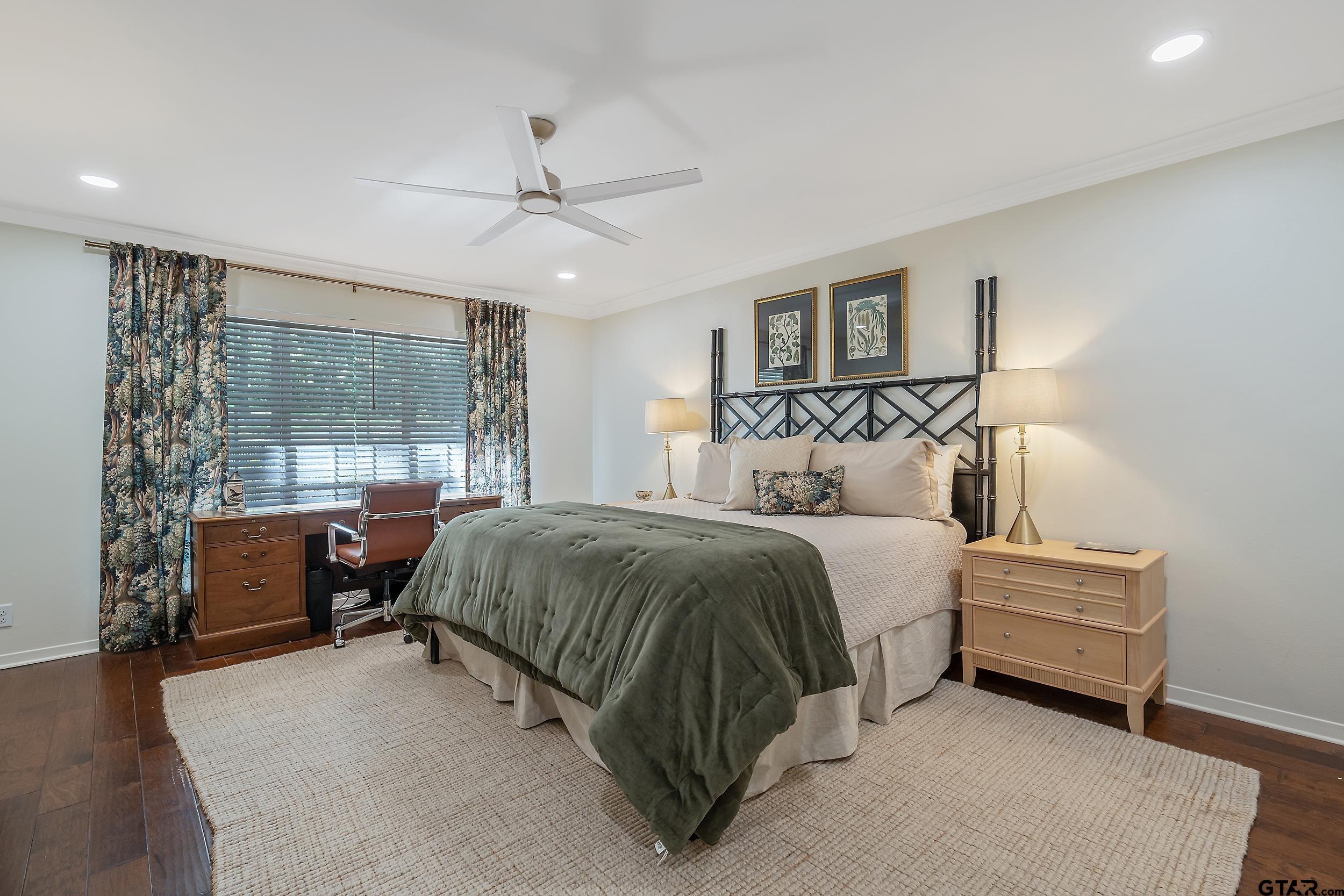 16708 Beddingfield Road Flint, TX 75762 - Photo 27 of 40 a spacious bedroom with a bed and wooden floor