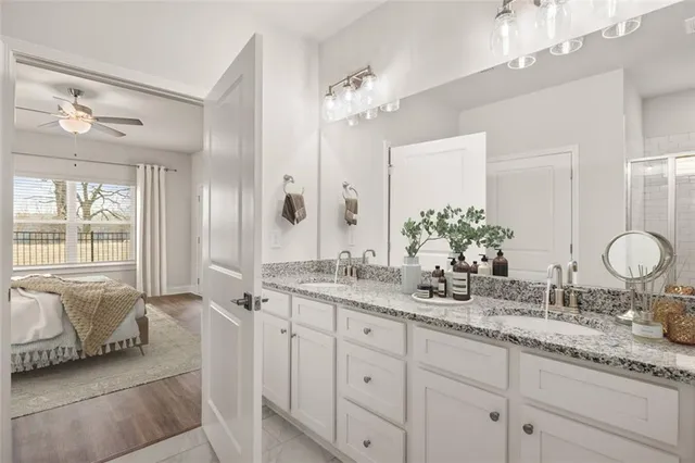 a bathroom with double vanity and a mirror