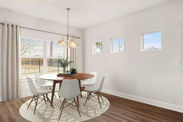 a view of a dining room with furniture window and wooden floor