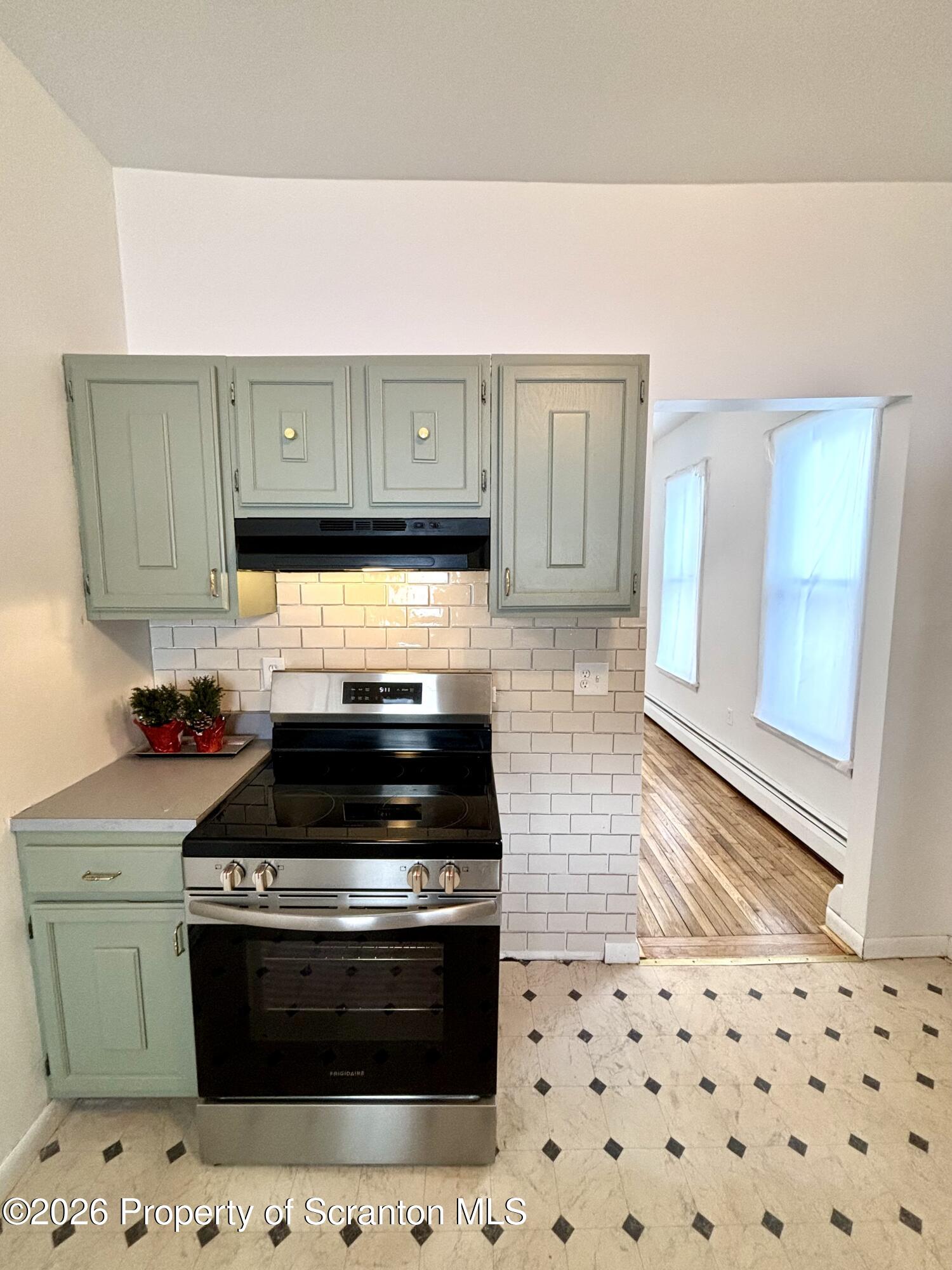 277 Riverside Drive Factoryville, PA 18419 - Photo 4 of 12 a kitchen with granite countertop a stove and a sink