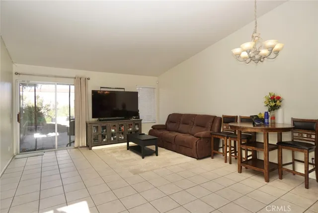 a living room with furniture and kitchen view
