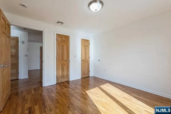 a view of an empty room and wooden floor