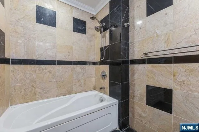 a bathroom with a bathtub and a shower