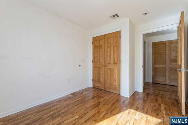 17 Meadow Road, Unit 401 Rutherford, NJ 07070 - Photo 18 of 29 a view of hallway with wooden floor