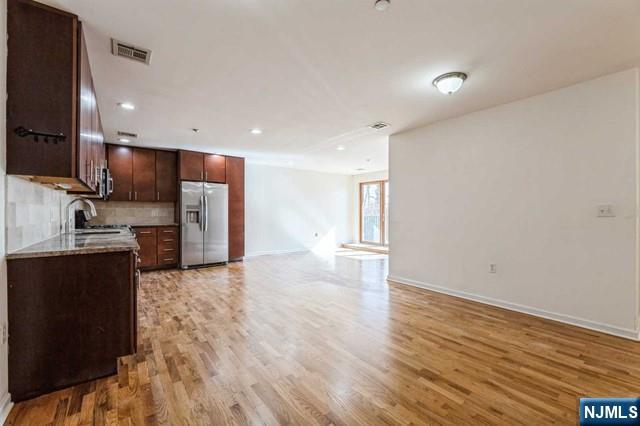 17 Meadow Road, Unit 401 Rutherford, NJ 07070 - Photo 2 of 29 a view of kitchen with refrigerator sink and cabinets