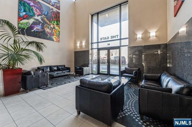 17 Meadow Road, Unit 401 Rutherford, NJ 07070 - Photo 25 of 29 a living room with furniture and a floor to ceiling window
