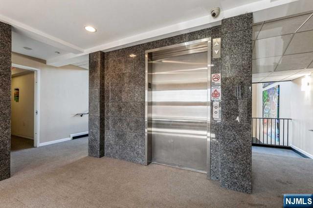 17 Meadow Road, Unit 401 Rutherford, NJ 07070 - Photo 27 of 29 a view of an empty room with a fireplace