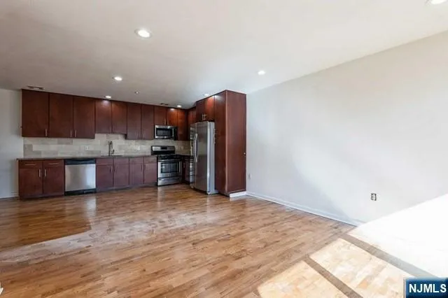 a view of kitchen with wooden floor