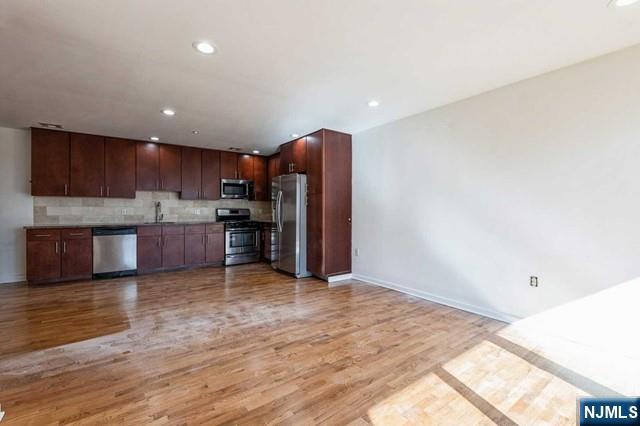 17 Meadow Road, Unit 401 Rutherford, NJ 07070 - Photo 6 of 29 a view of kitchen with wooden floor