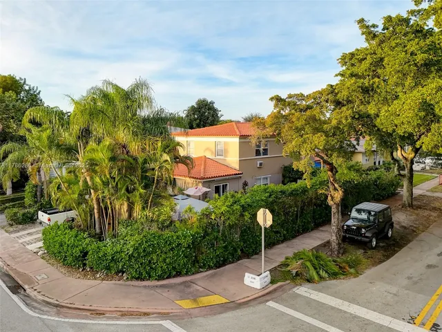 a backyard of a house with table and chairs