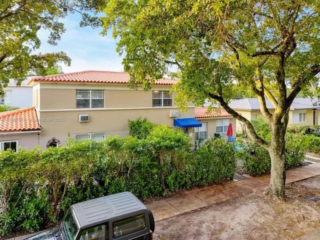 a bedroom with a bed table chair and a window