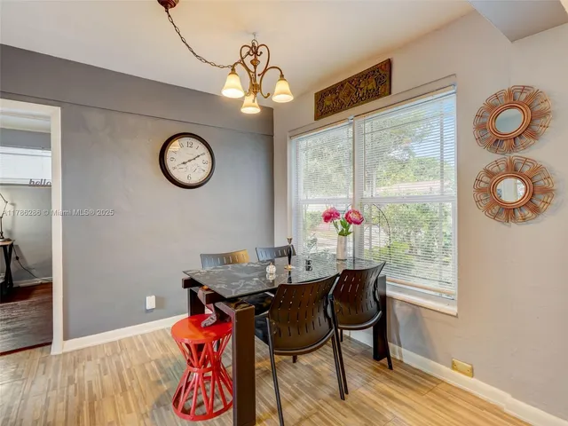 a view of a room with furniture and wooden floor