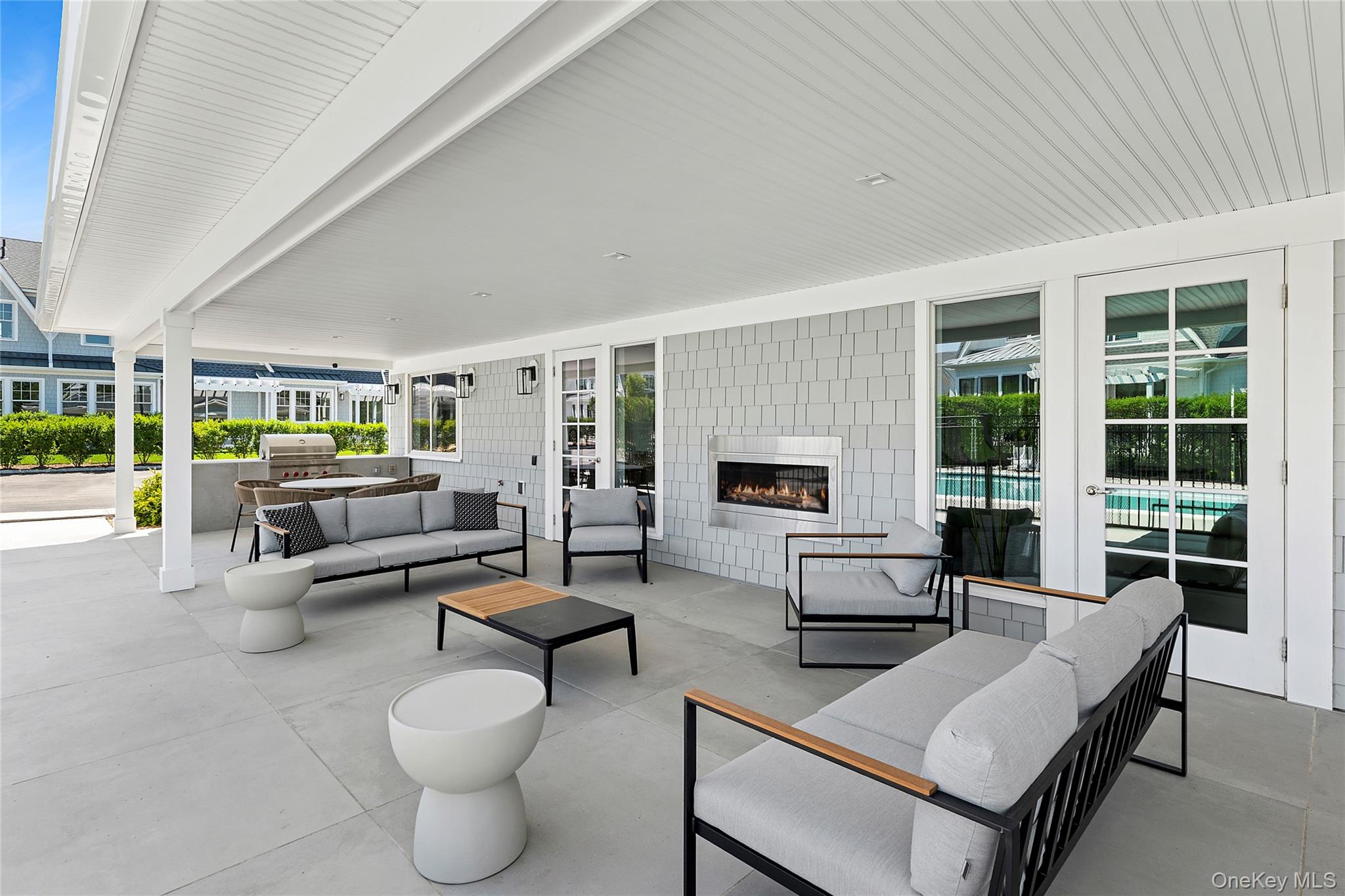 12 Depot, Unit 103 (PEARL WAY) Westhampton Beach, NY 11978 - Photo 14 of 28 a living room with furniture and a large window