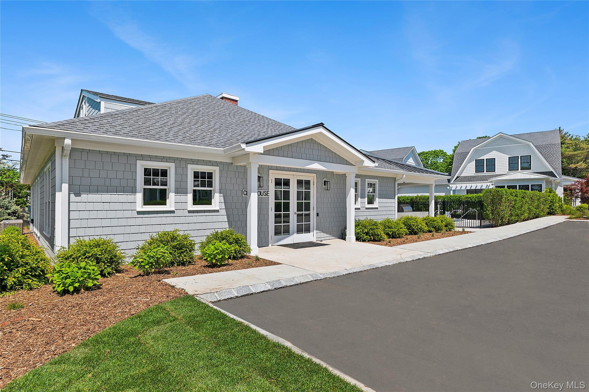 12 Depot, Unit 103 (PEARL WAY) Westhampton Beach, NY 11978 - Photo 15 of 28 a front view of a house with a garden