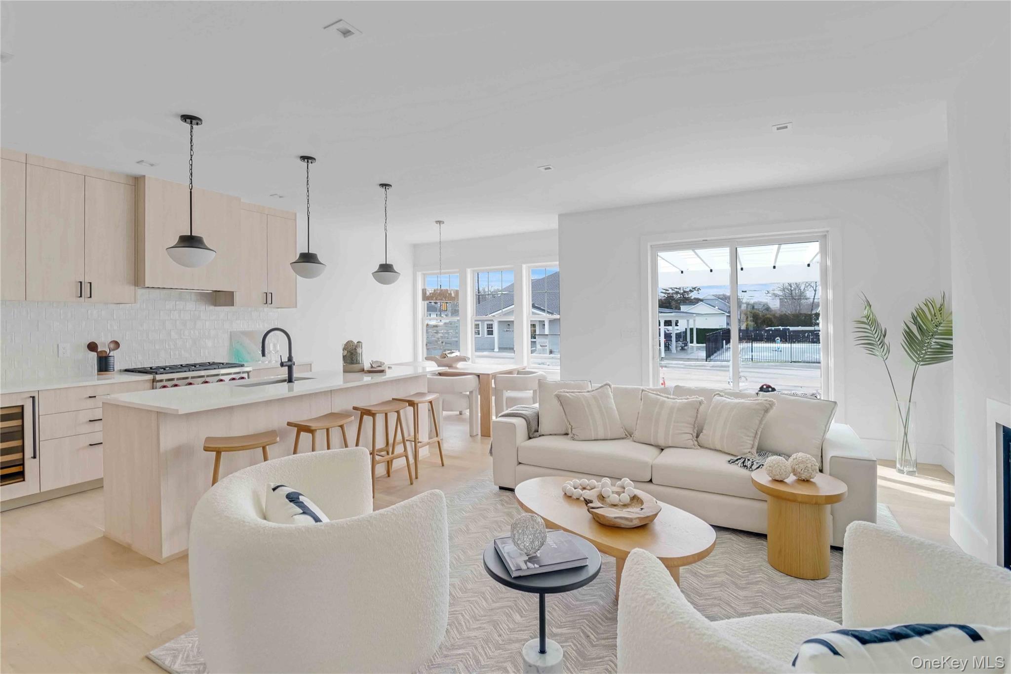 12 Depot, Unit 103 (PEARL WAY) Westhampton Beach, NY 11978 - Photo 3 of 28 a living room with furniture and a large window