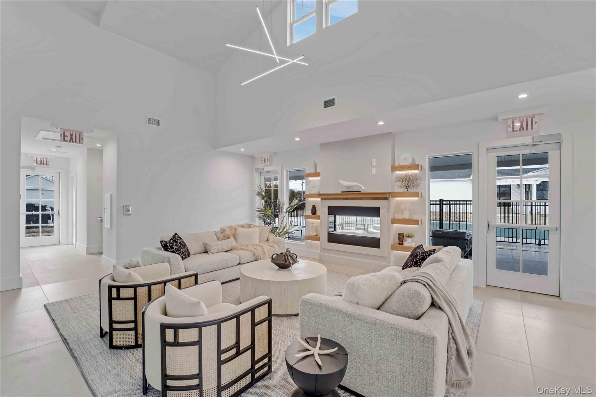 12 Depot, Unit 103 (PEARL WAY) Westhampton Beach, NY 11978 - Photo 8 of 28 a living room with furniture and a fireplace