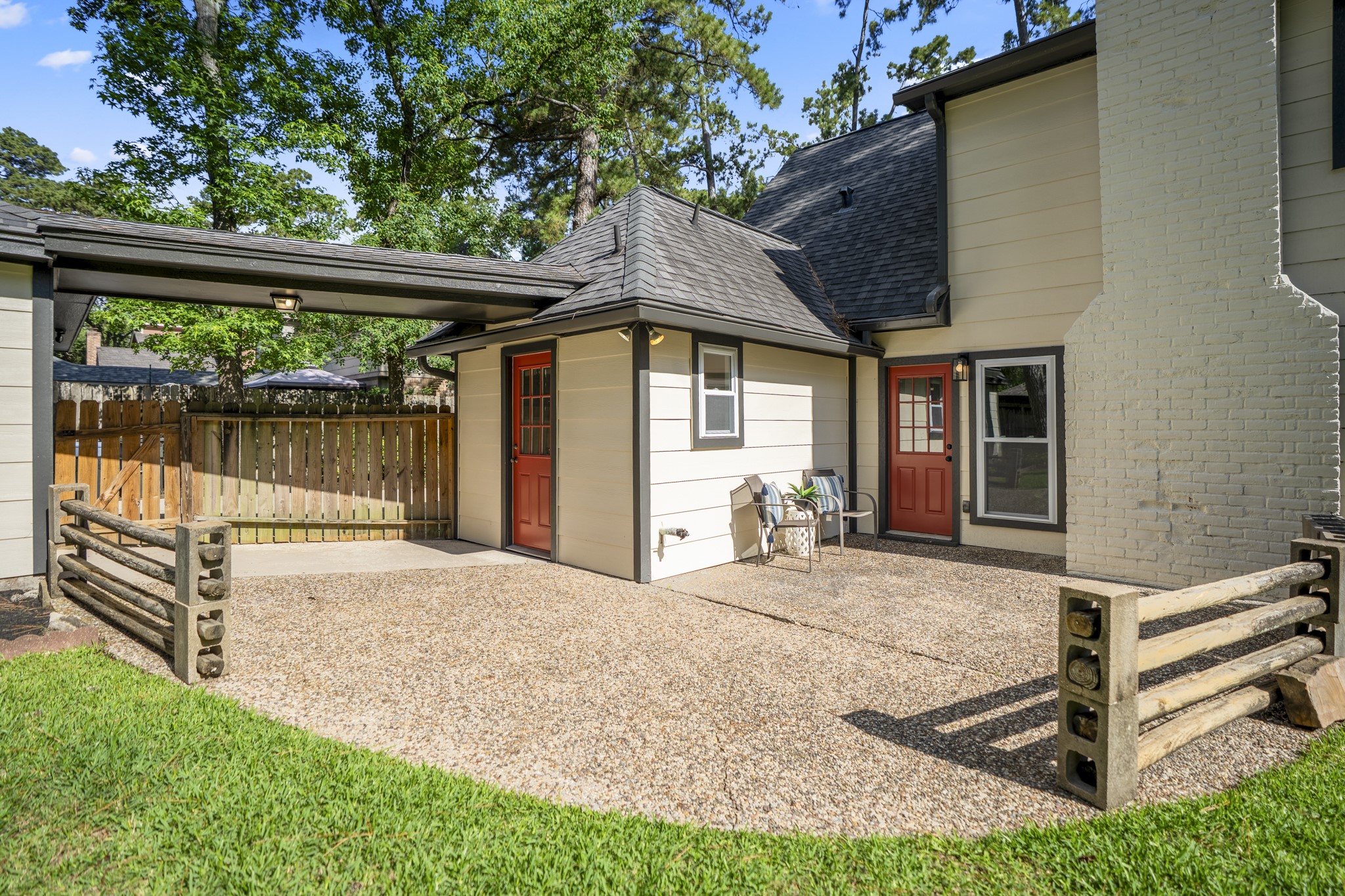 6303 Larkmount Drive Spring, TX 77389 - Photo 41 of 50 Looking back from the patio area, the rear exterior shows how the outdoor space connects to the home and detached garage. Updated siding, fresh exterior paint, and the covered walkway add to the clean, refreshed feel, while the patio creates a natural spot to enjoy the shade and backyard setting.