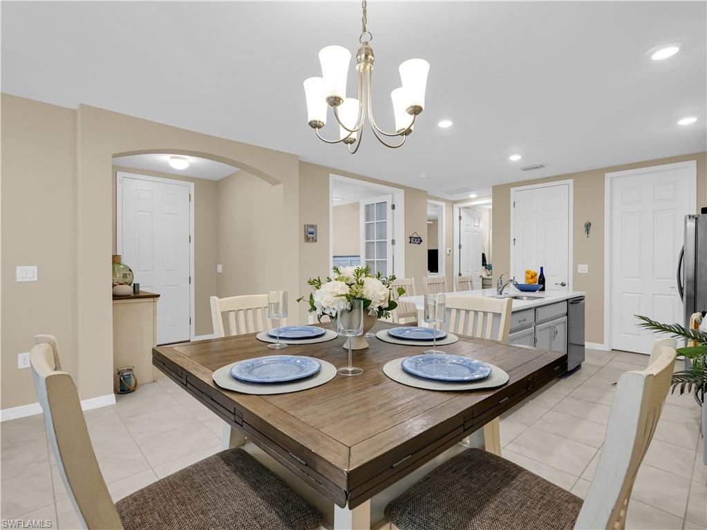 14695 Edgewater Circle Naples, FL 34114 - Photo 6 of 39 a view of a dining room with furniture and wooden floor