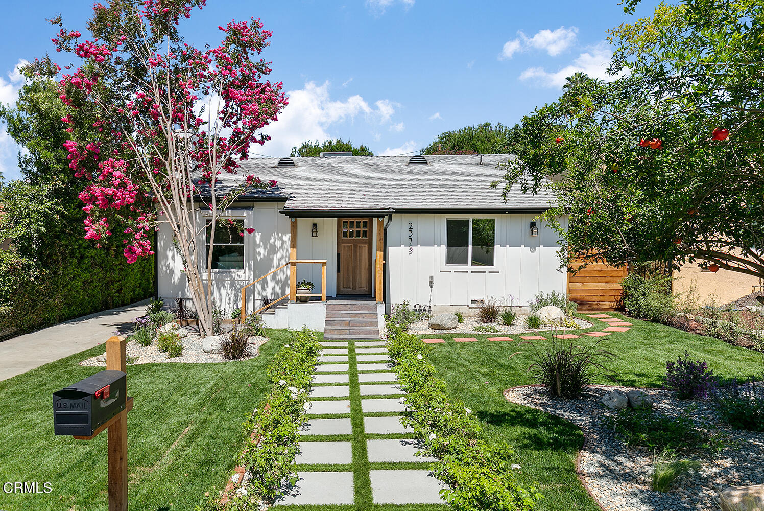 a front view of a house with garden