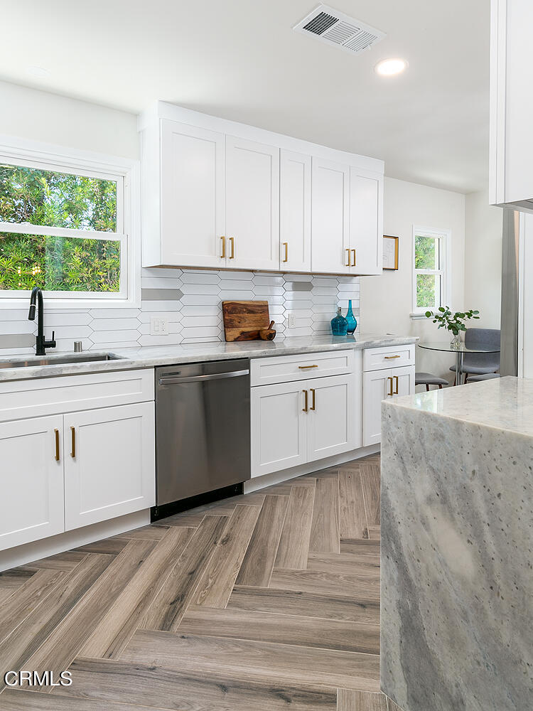 2375 Catherine Road Altadena, CA 91001 - Photo 14 of 50 a kitchen with stainless steel appliances granite countertop a sink window cabinets and granite counter tops