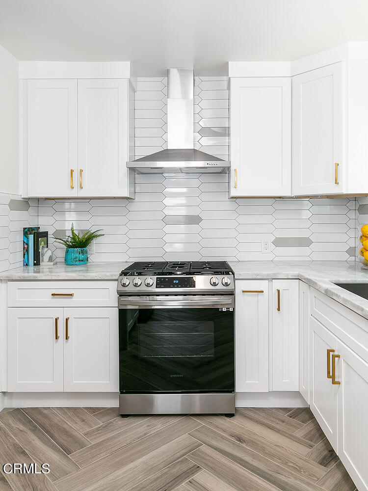 2375 Catherine Road Altadena, CA 91001 - Photo 15 of 50 a kitchen with stainless steel appliances granite countertop a stove a white cabinets and a window