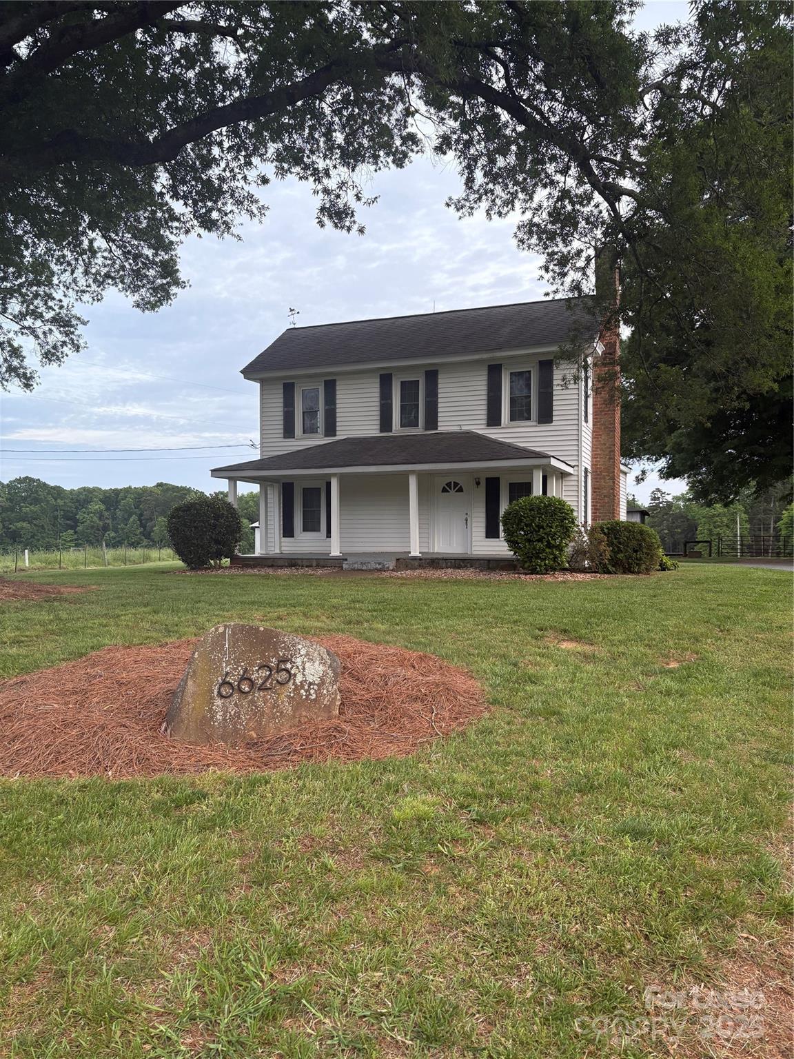 6625 Long Road Matthews, NC 28104 - Photo 1 of 23 a front view of a house with garden