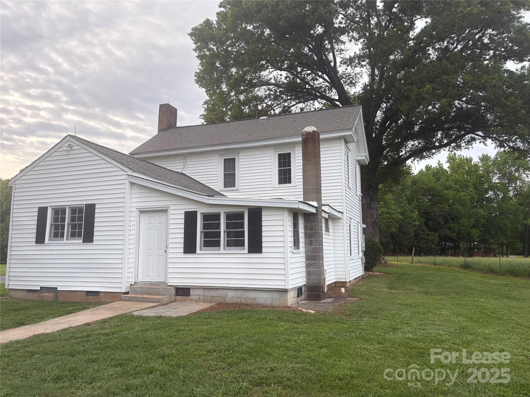 6625 Long Road Matthews, NC 28104 - Photo 16 of 23 a front view of a house with a garden