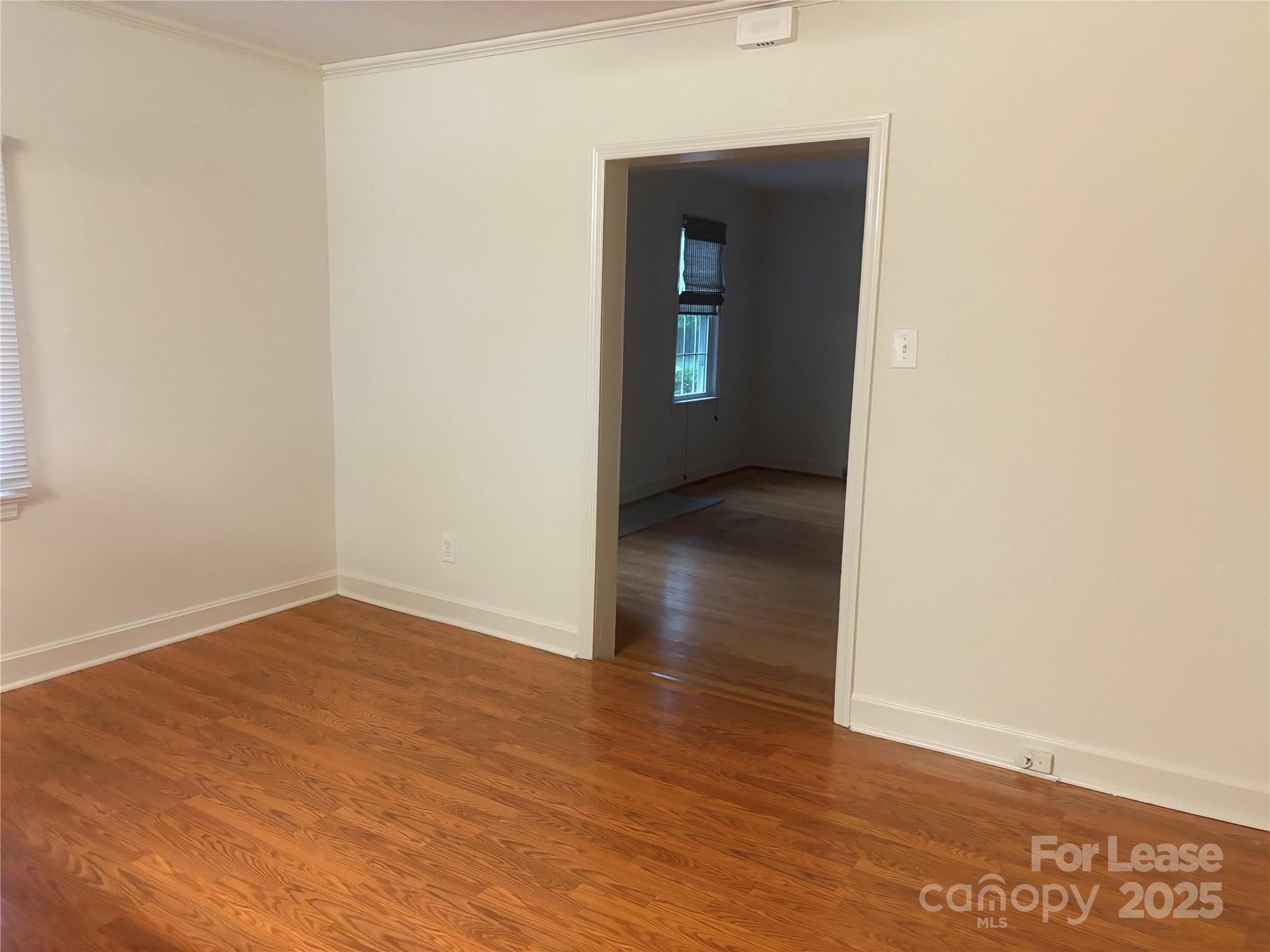 6625 Long Road Matthews, NC 28104 - Photo 9 of 23 an empty room with wooden floor and closet