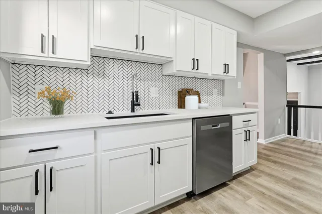a kitchen with white cabinets and white appliances