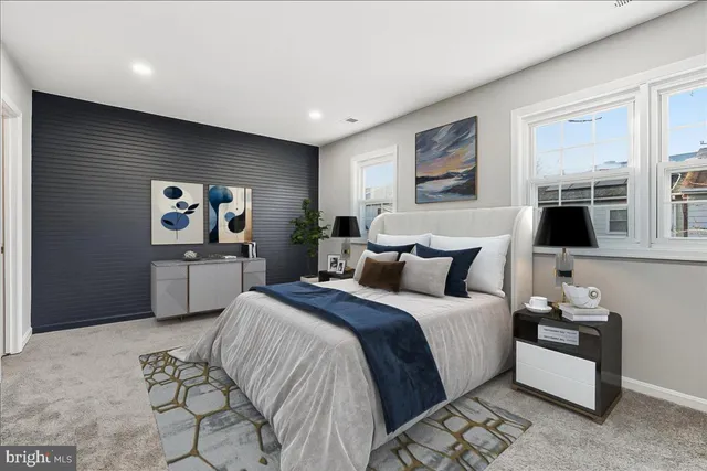 a large bedroom with a bed and glass wall painting