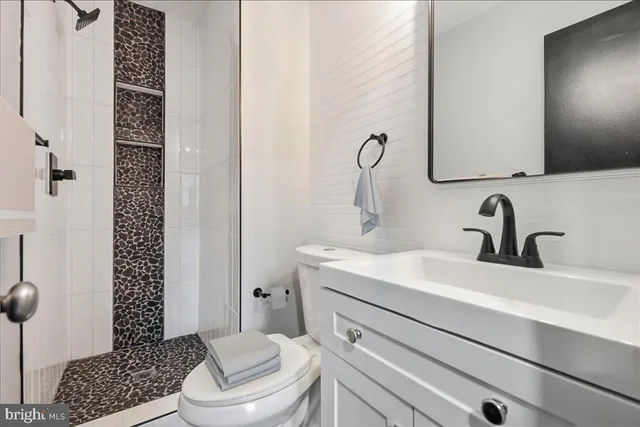 a bathroom with a sink toilet and shower