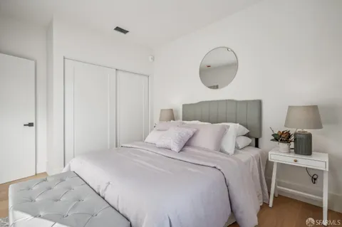 a bedroom with a bed and a painting