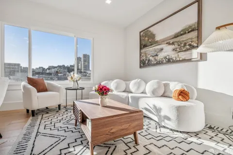 a living room with furniture and a potted plant