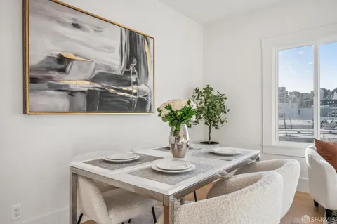 a dining room with furniture and wooden floor