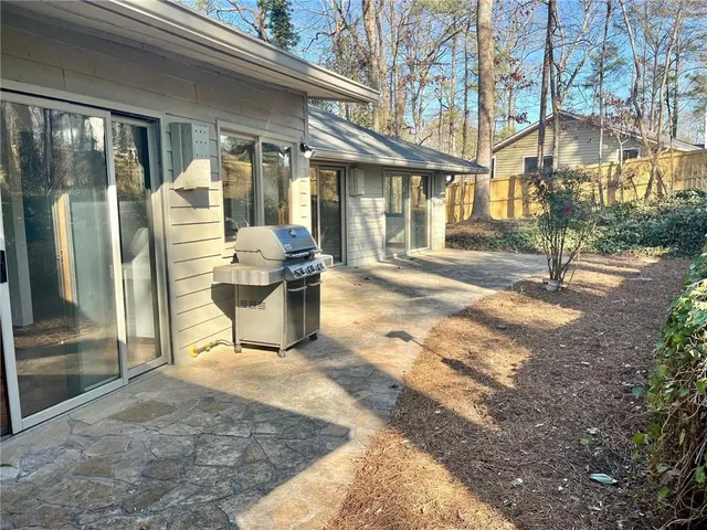a view of a brick house with many windows next to a road