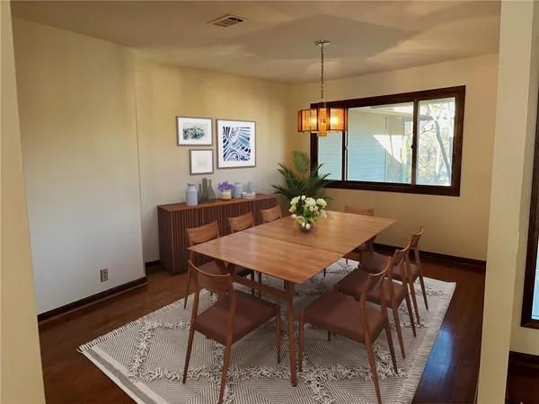 a view of a dining room with furniture and window