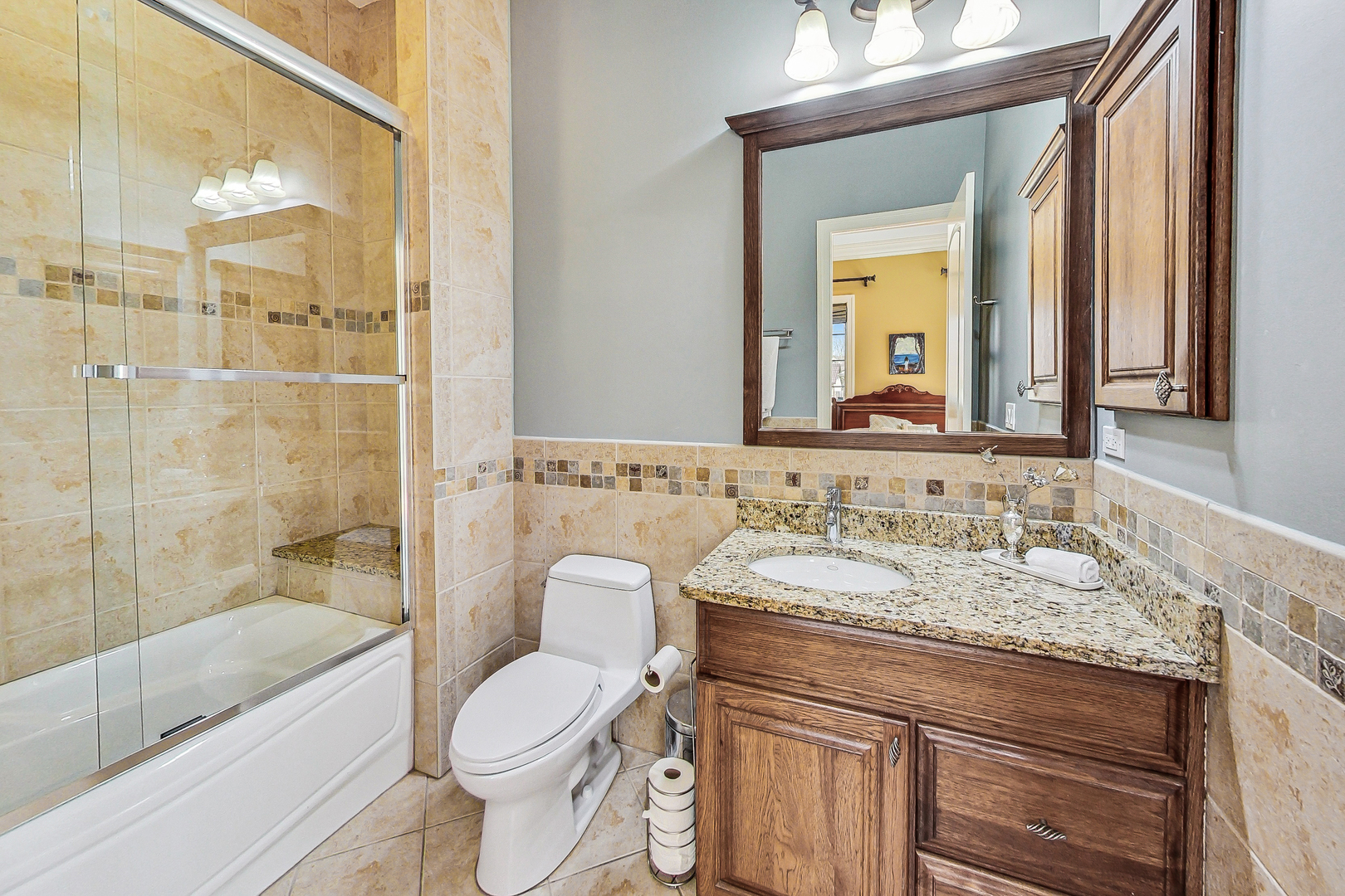 428 South Clifton Avenue Park Ridge, IL 60068 - Photo 12 of 43 a bathroom with a granite countertop toilet sink and mirror