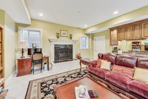 a living room with furniture fireplace and large window