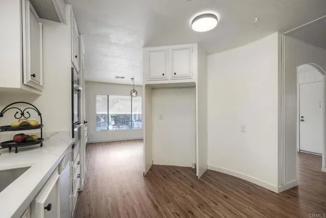a view of a kitchen with a sink and dishwasher wooden floor