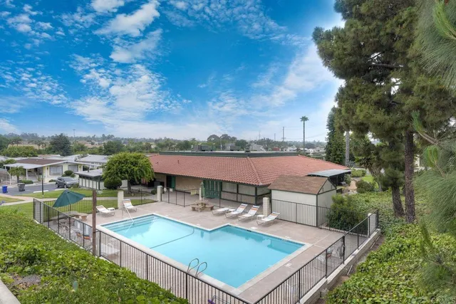 an aerial view of a house with swimming pool garden and patio
