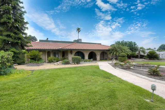 a front view of a house with swimming pool having outdoor seating