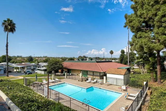 a view of a swimming pool with lounge chairs in patio