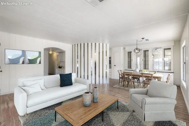 a living room with furniture and wooden floor