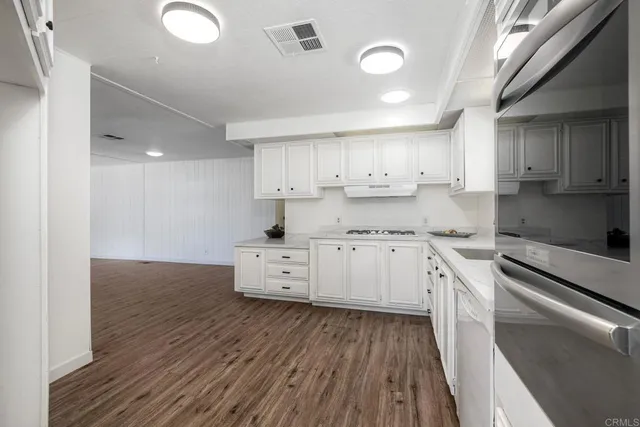 a kitchen with granite countertop a sink and cabinets