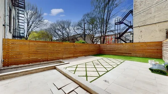 a picture of a bench in front of a wall