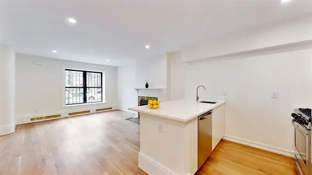 a kitchen with a sink and a stove top oven