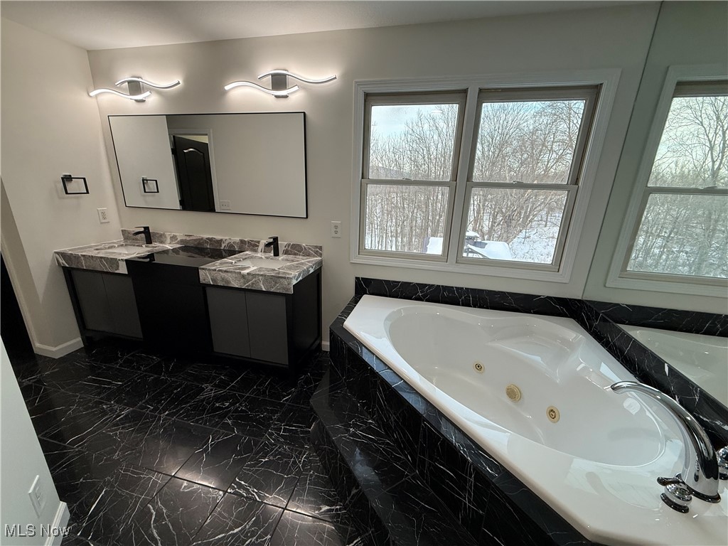 31295 Arthur Road Solon, OH 44139 - Photo 28 of 50 Bathroom with tiled tub and vanity